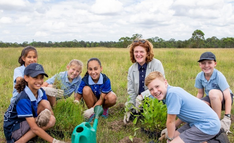 School kids planing trees with Execuive Director Suellen Fitzgerald